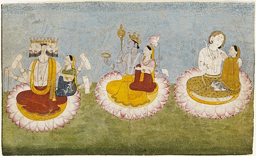 Brahma, Vishnu and Shiva seated on lotuses with their consorts, Saraswati, Lakshmi and Paravati respectively.