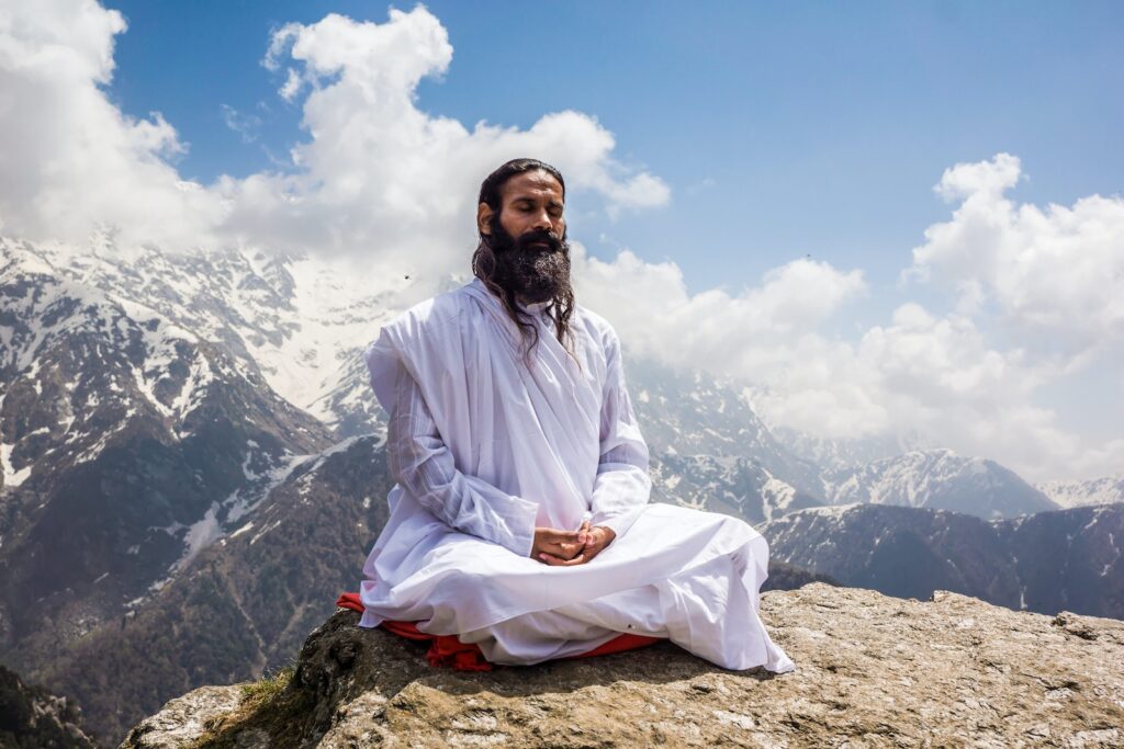 A Man in White Thobe Meditating on the Mountain Top